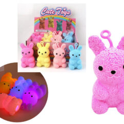 Stressivastased pehmed jänkud roosad, kollased, roosad ja helesinised istuvad karbi kõrval.